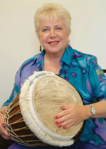 Dr. Elizabeth M. Jacobi playing a drum
